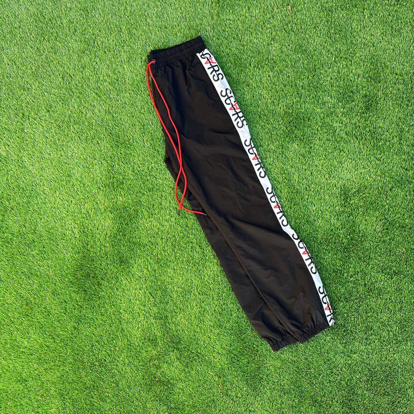 HELLA SCARS TRACK PANTS